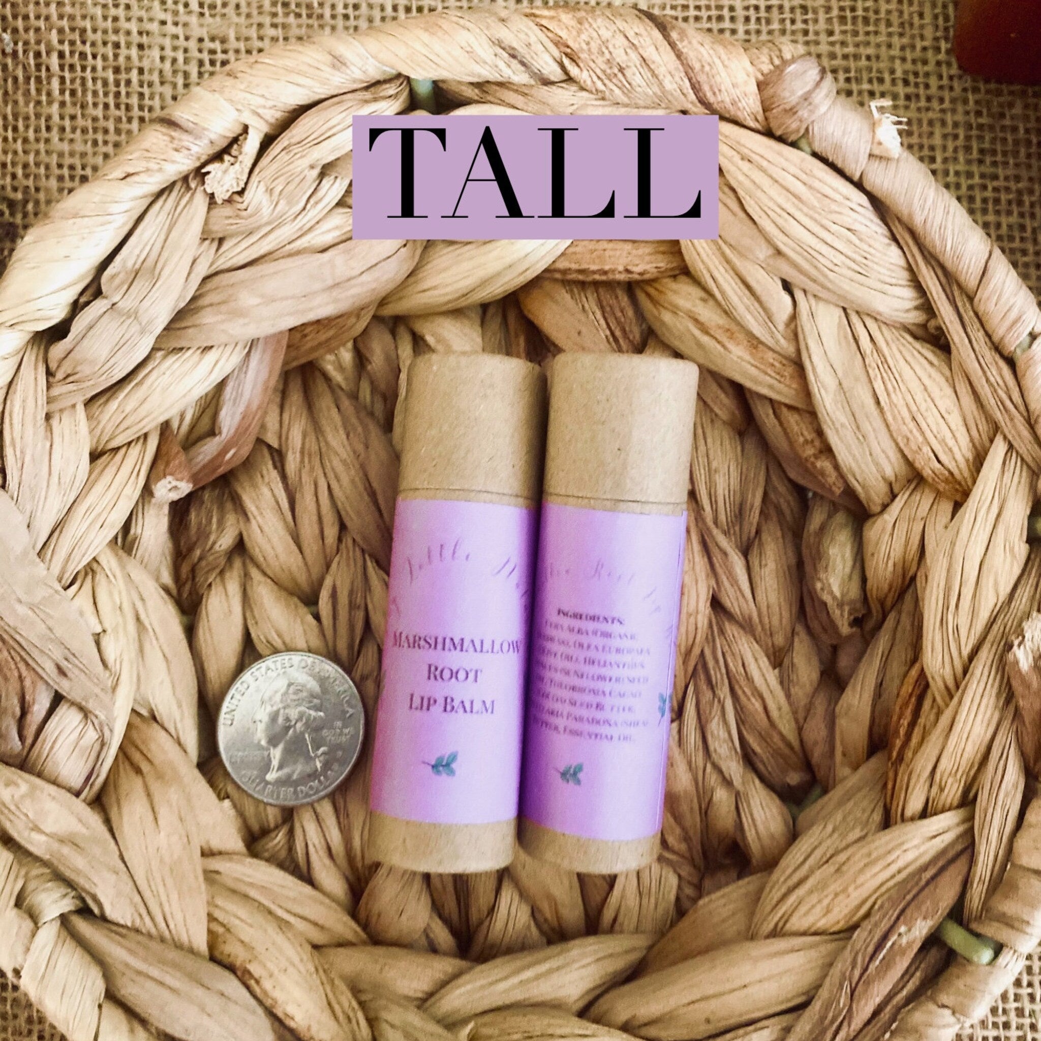 Lip balm tubes with brown and purple labels, in woven basket, with coin for scale