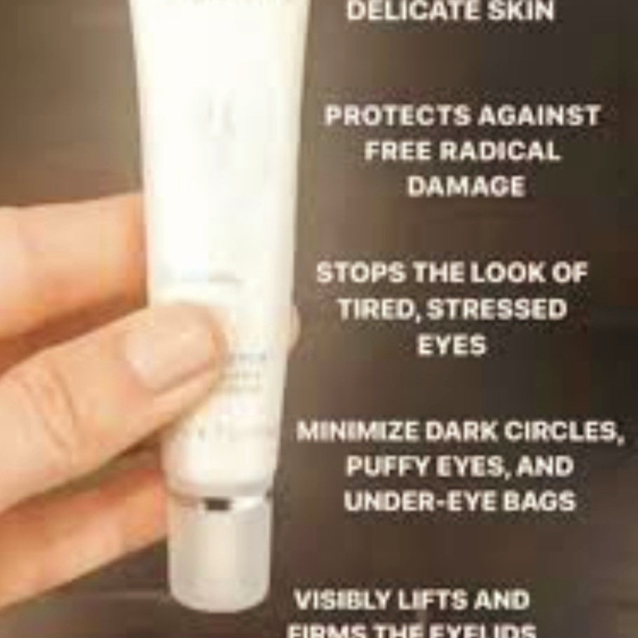 Eye cream tube, white and silver, held by hand, for delicate skin