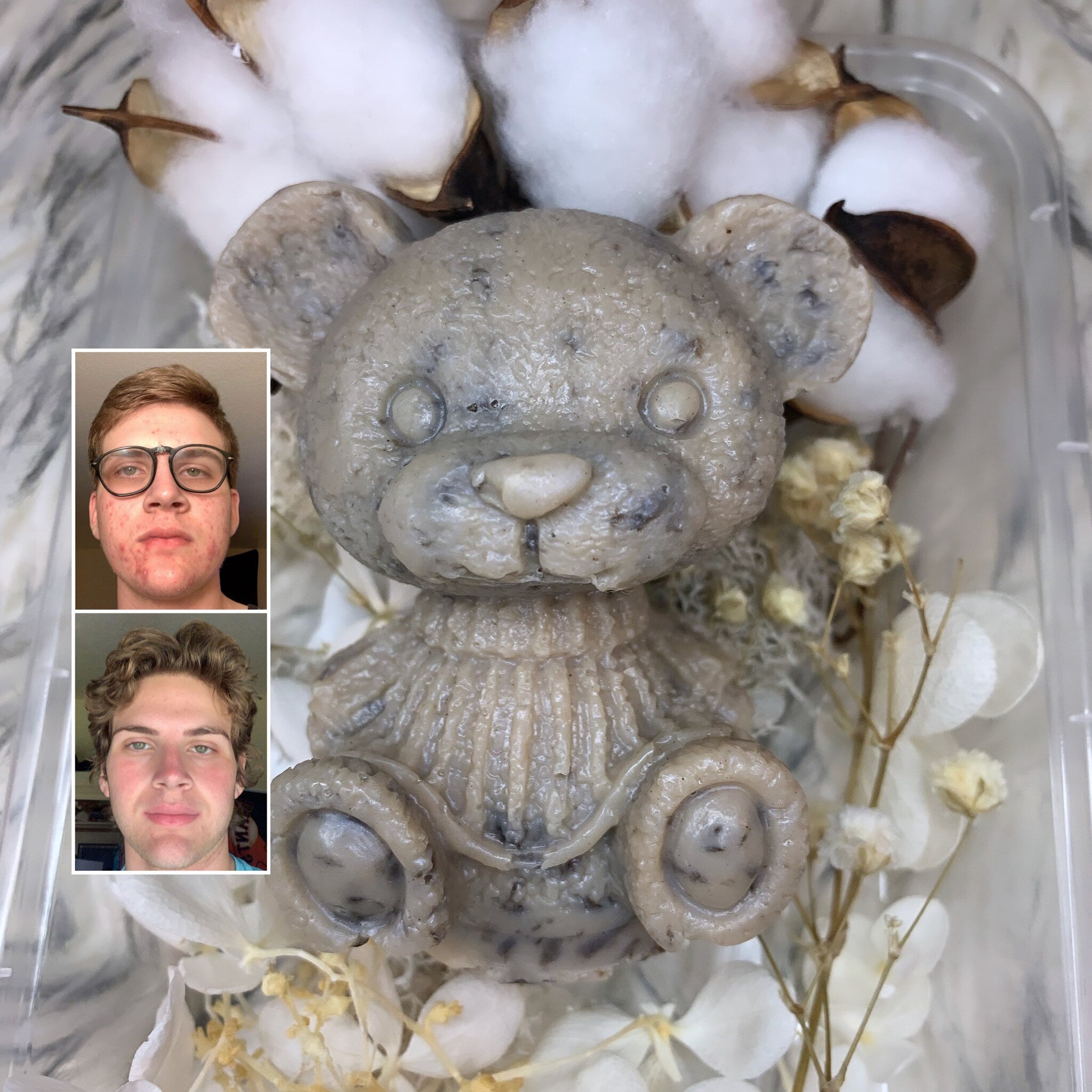 Bear shaped soap, gray colored, textured soap, with cotton and flowers in container.
