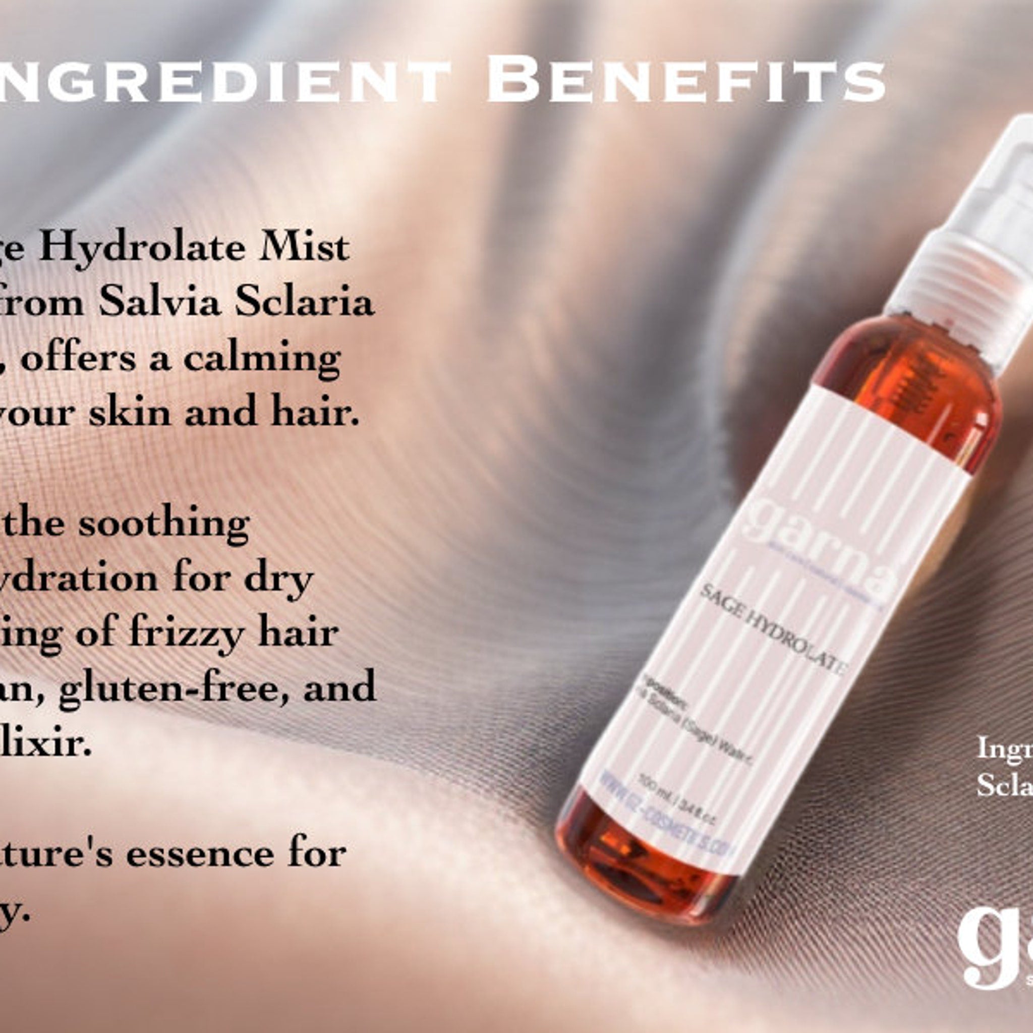Sage Hydrolate Mist bottle, orange liquid, white label with brand name, on a soft fabric background