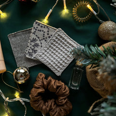 Coasters gray waffle, patterned, and woven fabric, with Christmas decorations around them