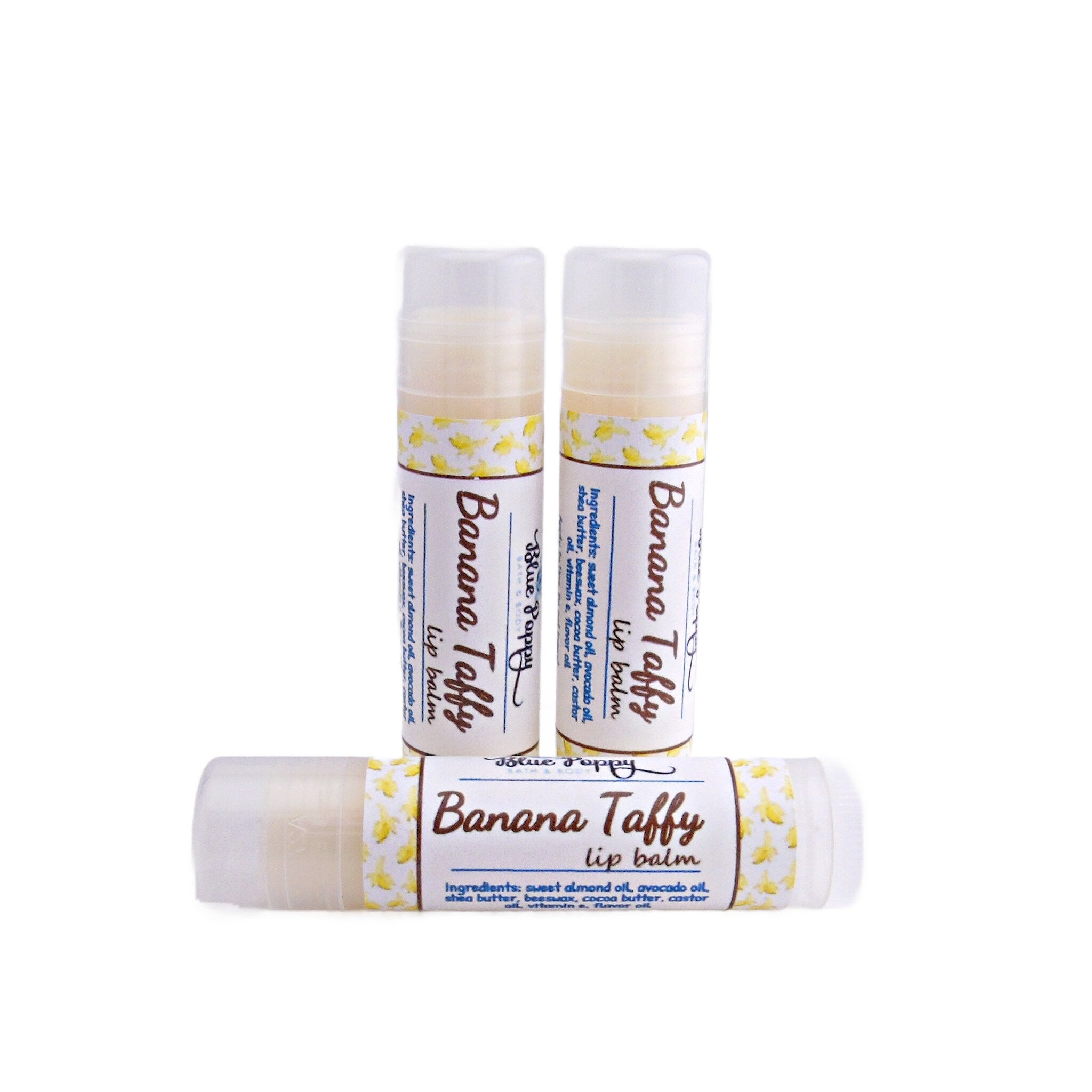 Lip balm tubes with white and yellow pattern, featuring "Banana Taffy" text and ingredients list, Blue Poppy brand