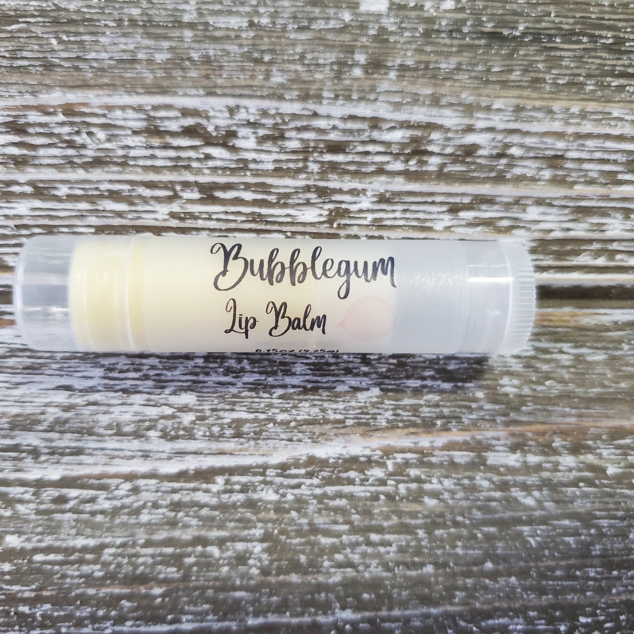 Lip balm tube with clear plastic, yellow balm, and "Bubblegum Lip Balm" text on label