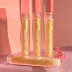 Lip gloss tubes with gold shimmer, pink cap, and "All That Shimmers" text, by PinkishPurrple