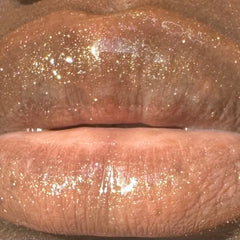 Lip gloss, shimmering gold glitter, glossy finish, close-up of lips