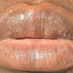 Lip gloss with shimmering glitter, light pink color, and glossy finish
