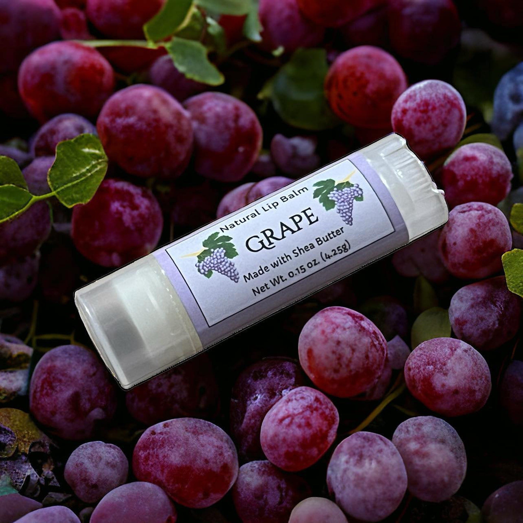 Lip balm tube with white label, clear plastic, and grape flavor text on label