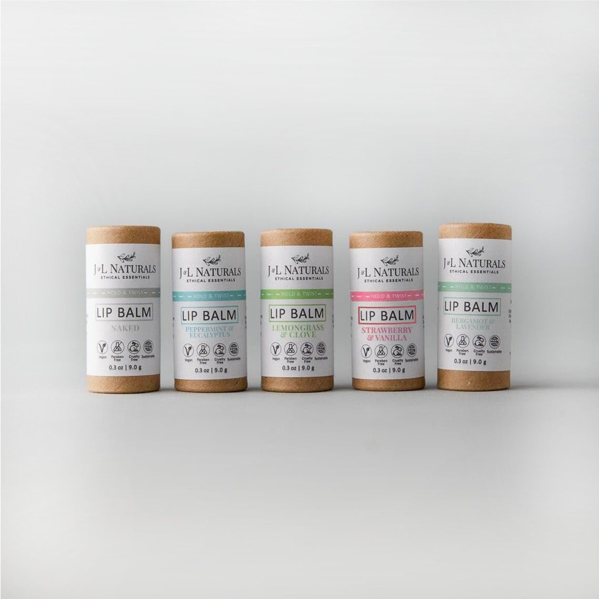 Lip balm tubes in brown cardboard with white labels and colored text, J&L Naturals brand