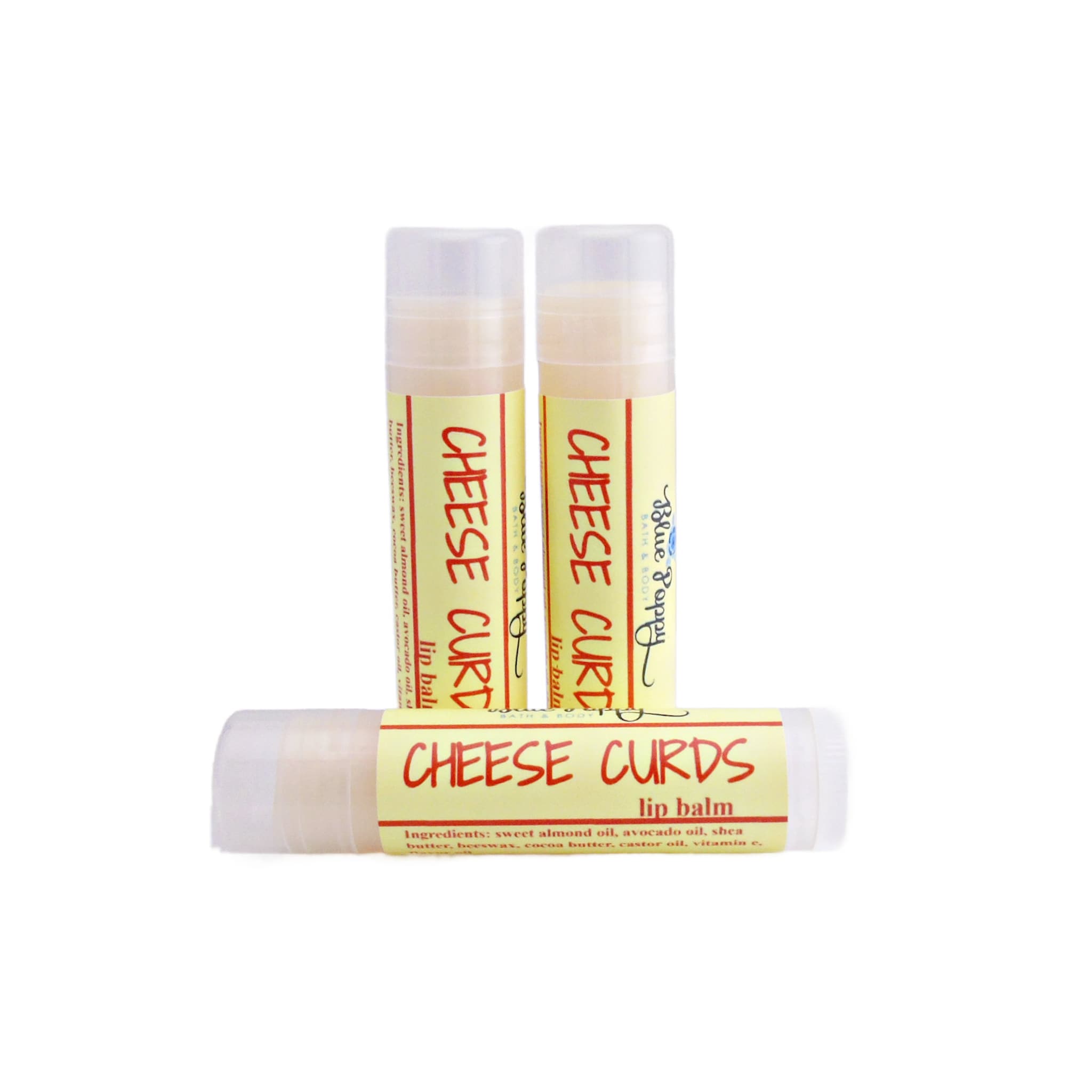 Lip balm tubes with yellow labels, white tubes, and "Cheese Curds" text