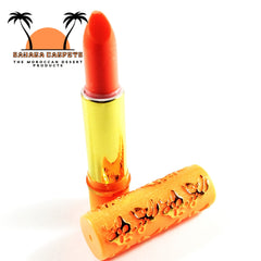 Lipstick with red color, gold tube, and orange patterned cap, Moroccan Magic brand visible