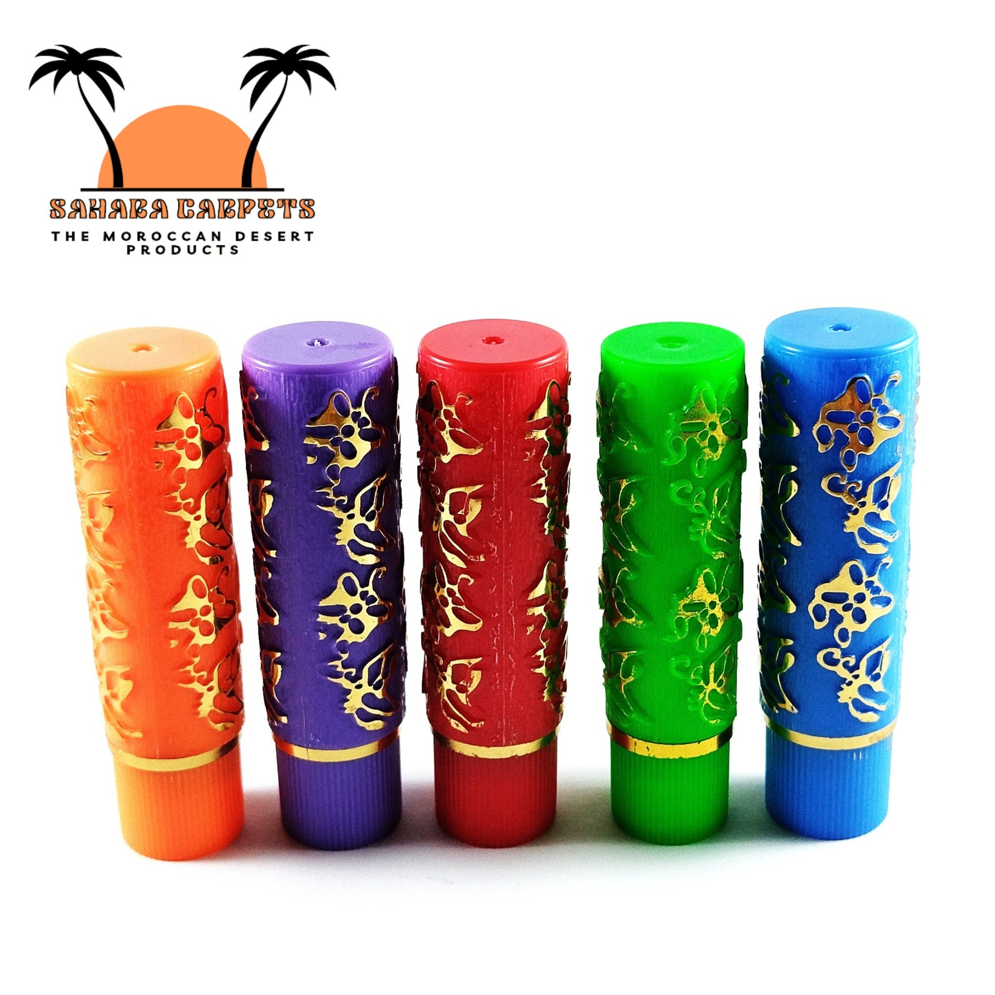 Colorful cylindrical bottles with gold filigree pattern, Sahara Carpets brand name visible.