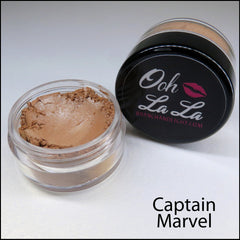 Side view of round brown and neutral vegan mineral eye shadow jar showing texture and size