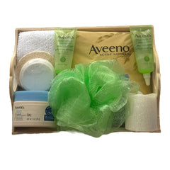 Aveeno gift basket with green, white, and wood-tone items for bath and body care