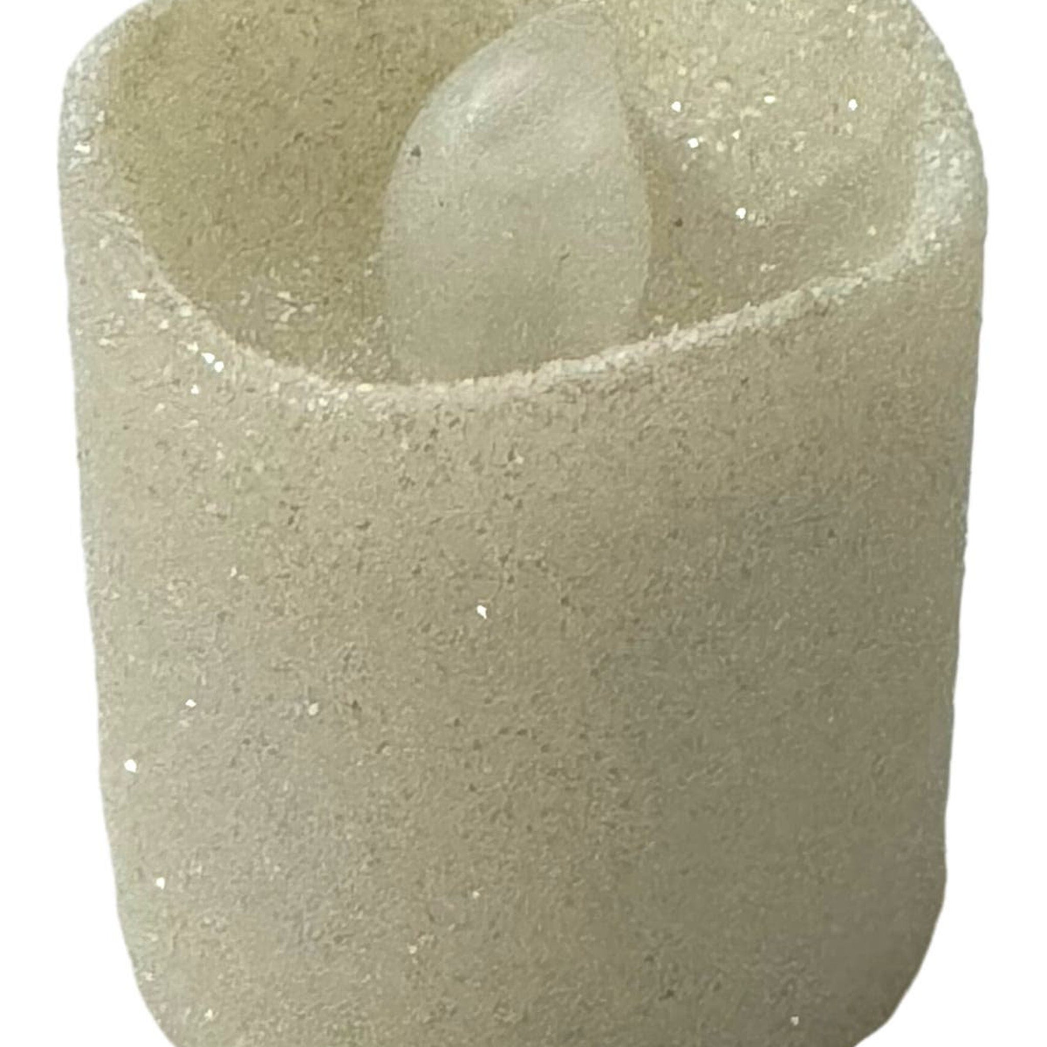 Glitter candle with beige color and textured surface, candle shape