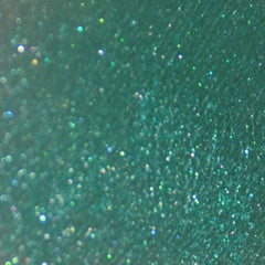 Side view of pigmented mineral eye shadow jar with sifter lid, showcasing container height and texture