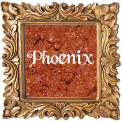Small glass jar with black lid containing pigmented phoenix-orange mineral eye shadow and sifter insert