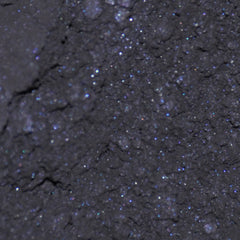 Side view of matte black mineral eye shadow jar with sifter, showcasing compact cylindrical design and product depth