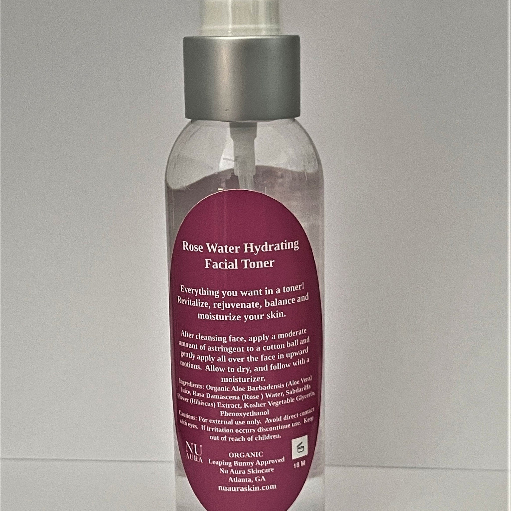 Facial Toner bottle with silver cap, clear glass, and Nu Aura label in pink