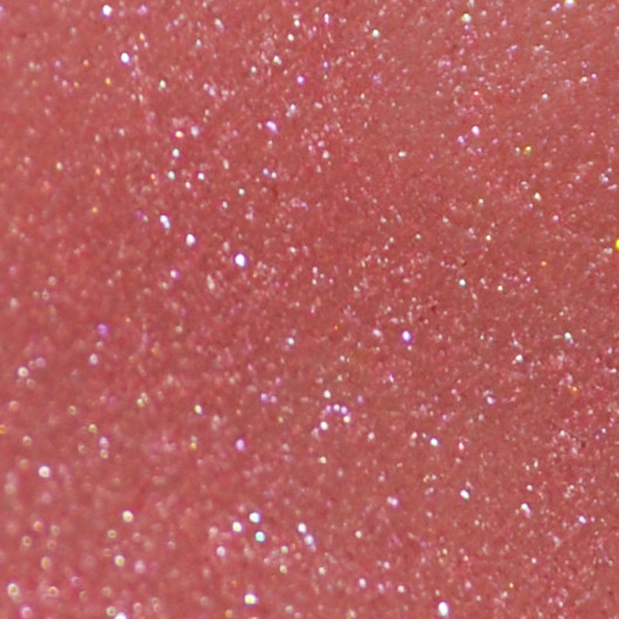 Side view of pink mineral eye shadow jar with sifter lid showing pigmented powder texture