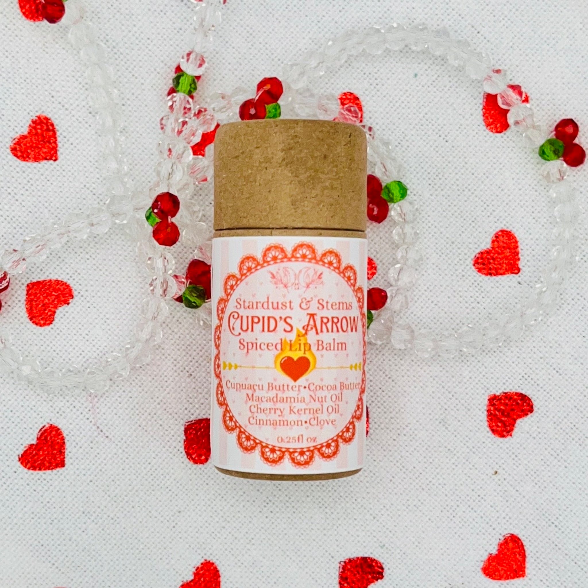 Lip balm tube with brown cap, pink and white label, and brand name Cupid's Arrow visible