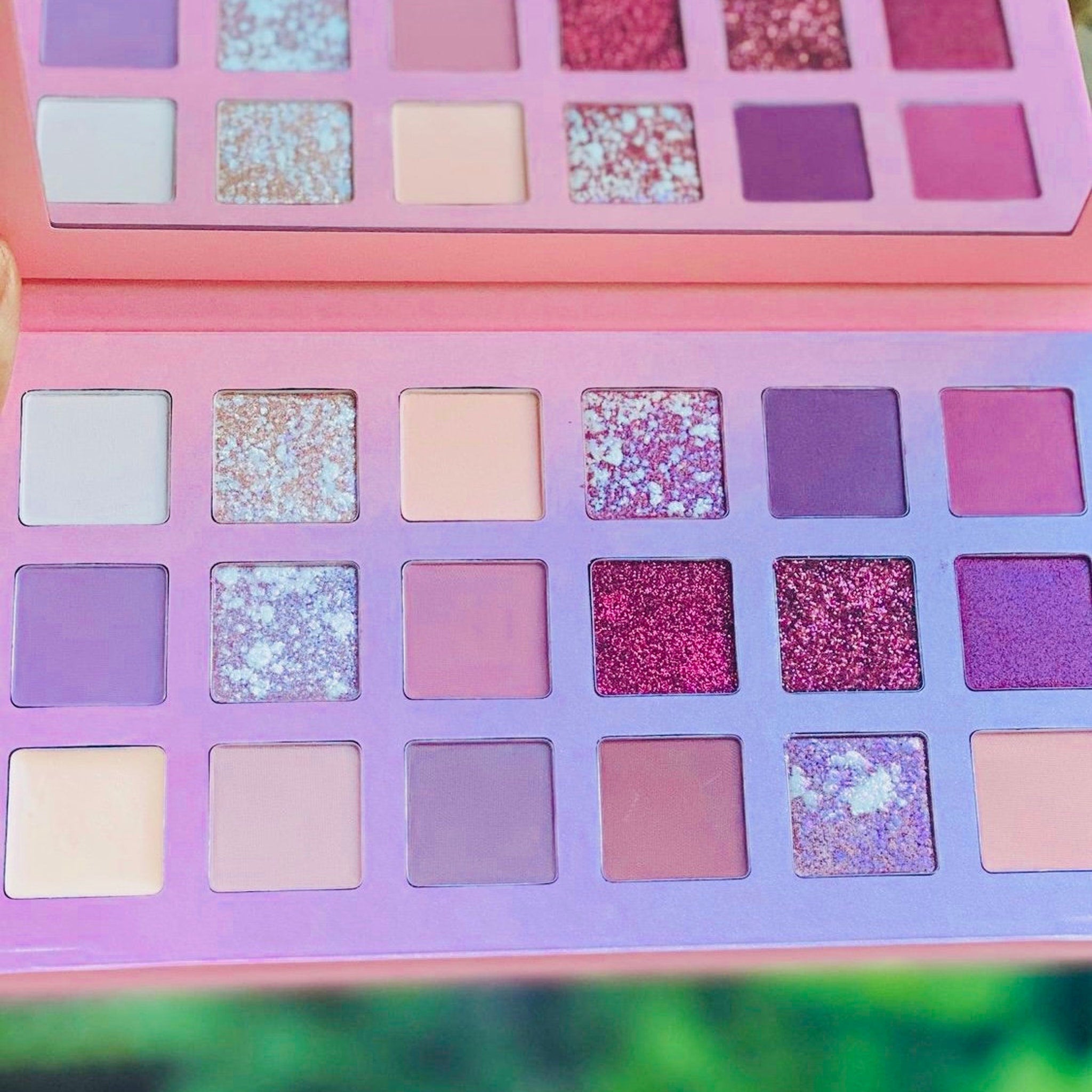 Rose gold eyeshadow palette with six shimmering shades in warm metallic tones, displayed open