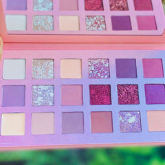 Rose gold eyeshadow palette with six shimmering shades in warm metallic tones, displayed open