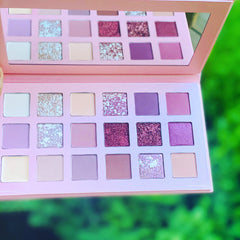 Side view of rose gold eye shadow palette showing six shimmering shades with mirrored compact design