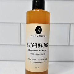 Golden-hued turmeric and kojic acid face and body wash in a sleek amber bottle with minimalist typography
