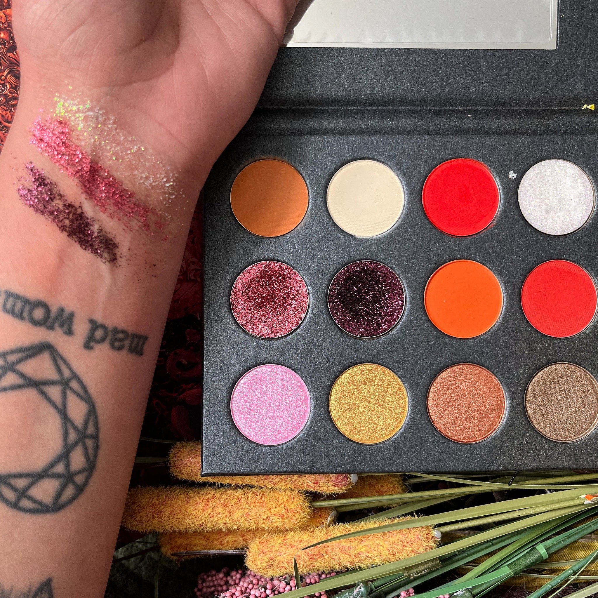 Close-up of shimmering bronze and gold eyeshadow pans with glitter particles in Bryce Quinlan palette
