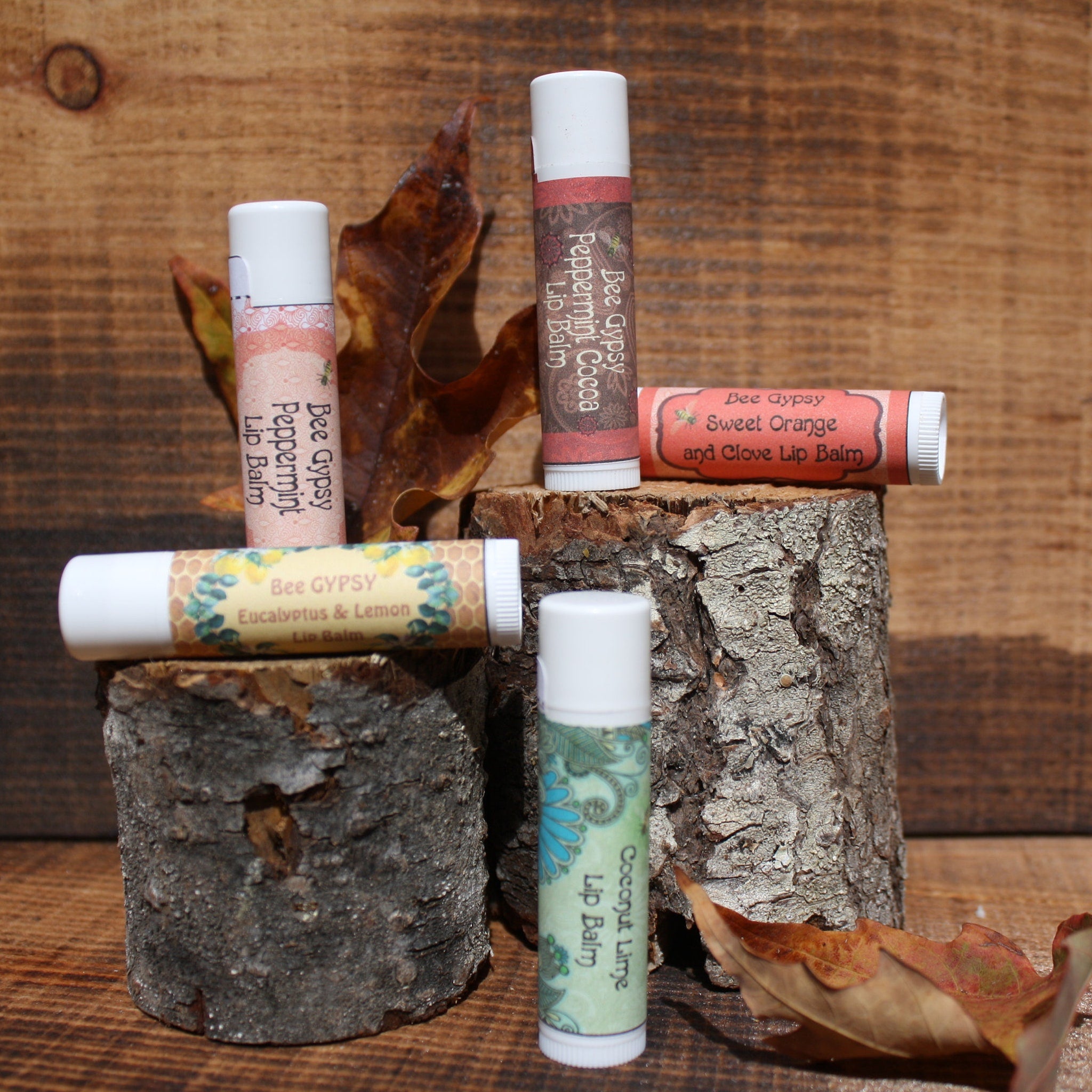 Lip balms with white tubes, patterned labels, and Bee Gypsy brand text on display