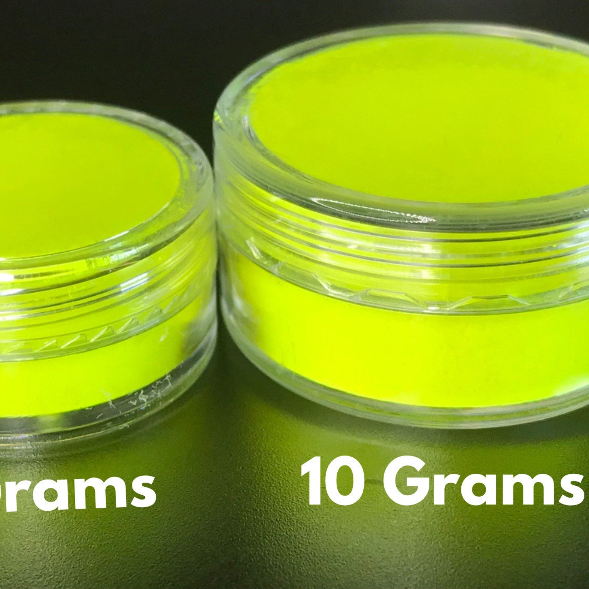 Open palette displaying eight vibrant neon matte eyeshadows in round pans with UV glow effect