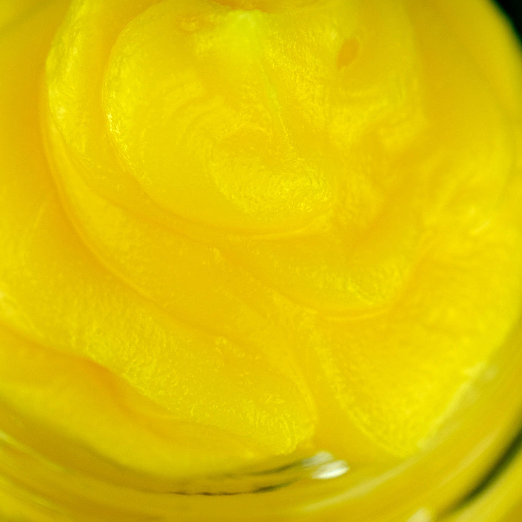 Yellow swirl with smooth texture and glossy finish, close-up view