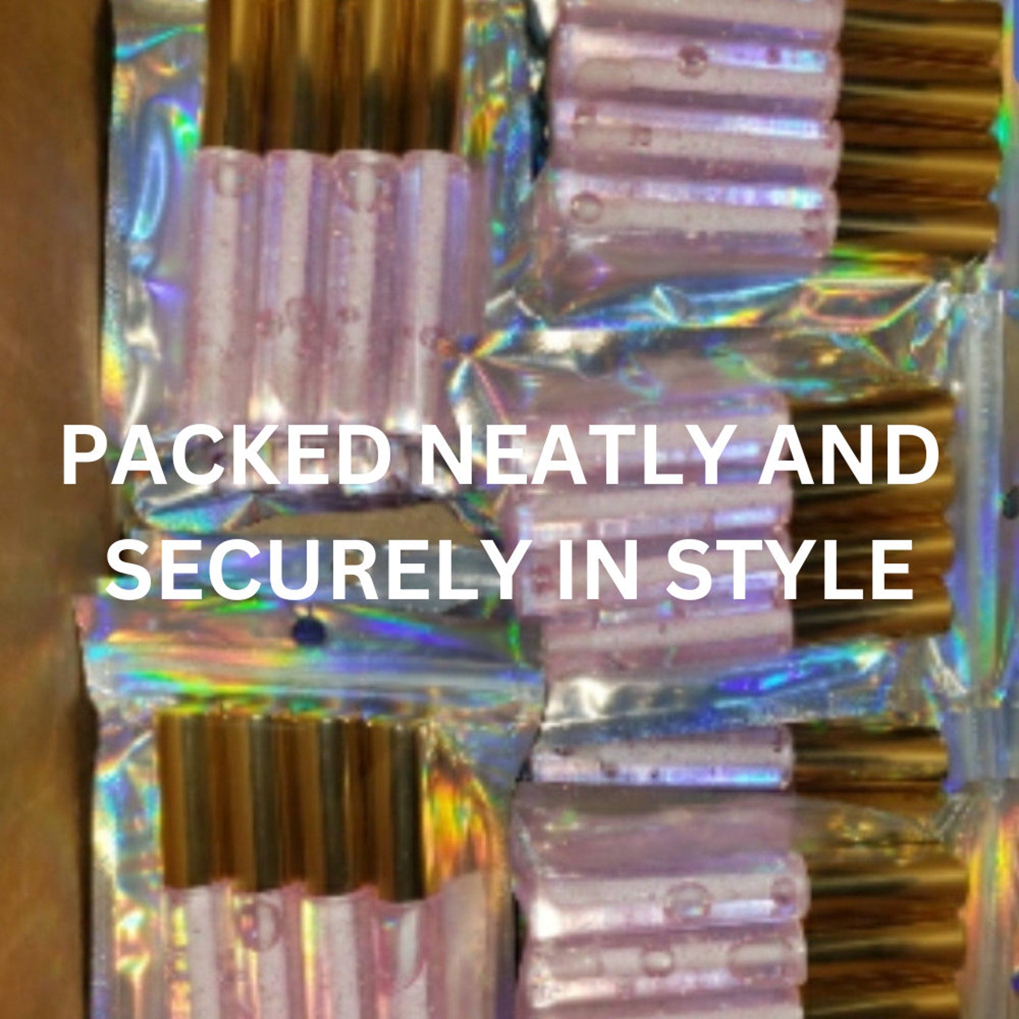 Lip gloss tubes in pink and gold, packaged in holographic bags, neat display
