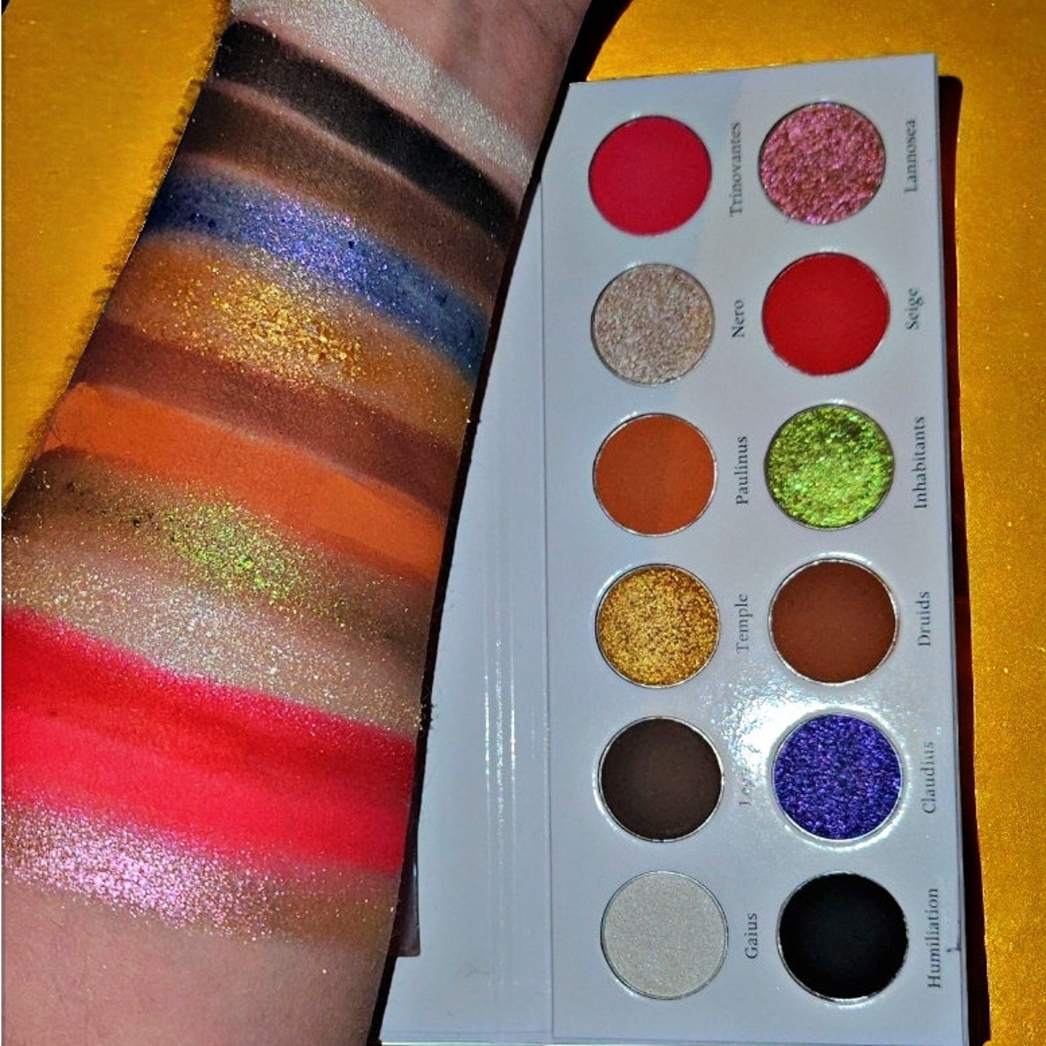 Side view of Boudica Eye Shadow Palette showing gradient of matte and shimmer shades in rectangular pans