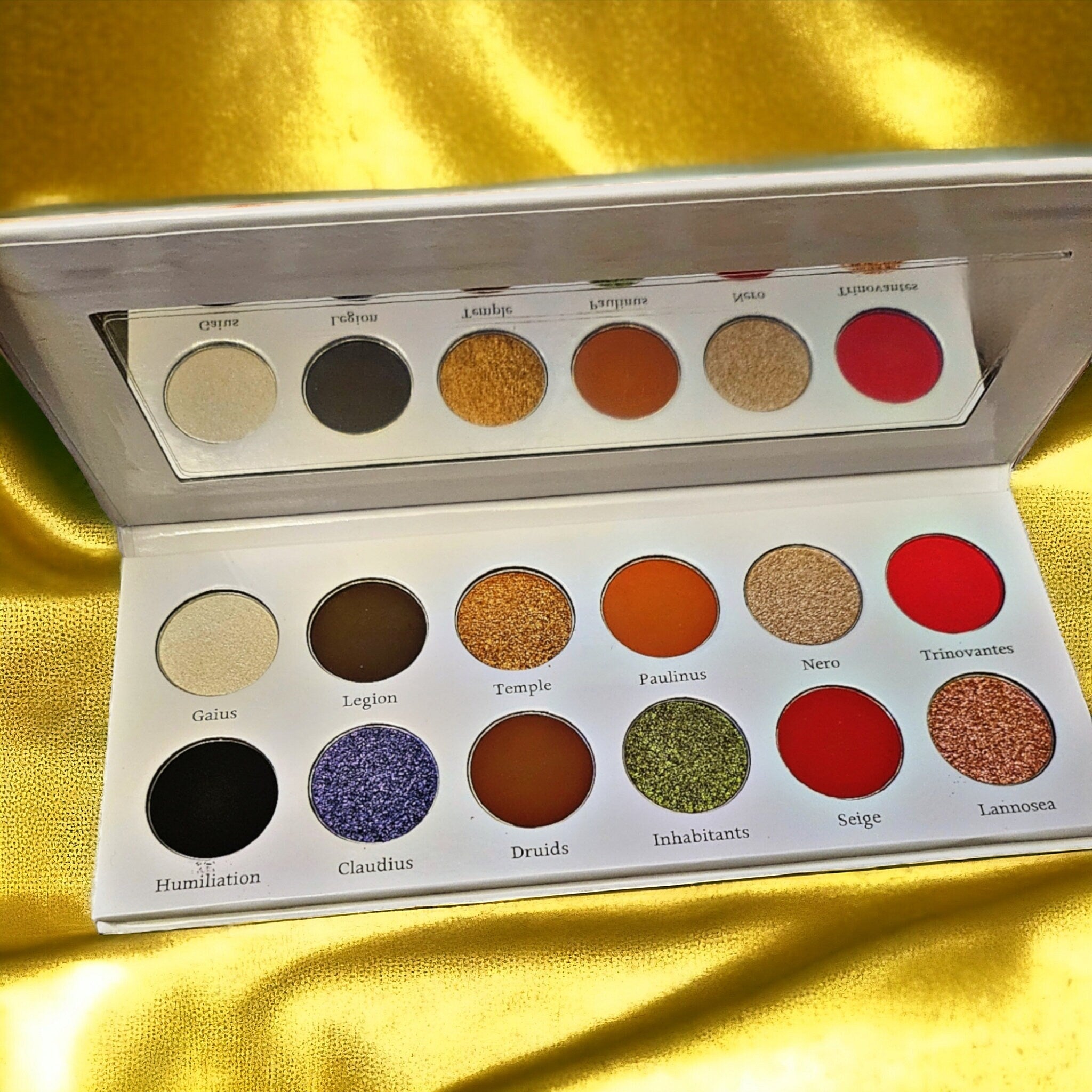 Boudica Eye Shadow Palette featuring 12 vibrant matte and shimmer shades in a sleek black compact