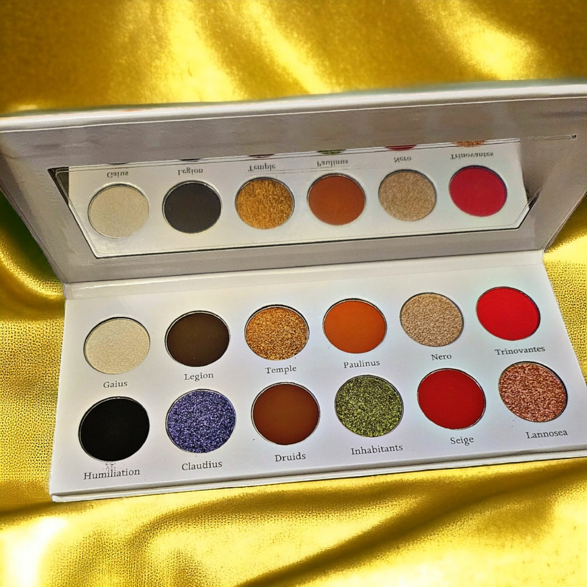 Boudica Eye Shadow Palette featuring 12 vibrant matte and shimmer shades in a sleek black compact