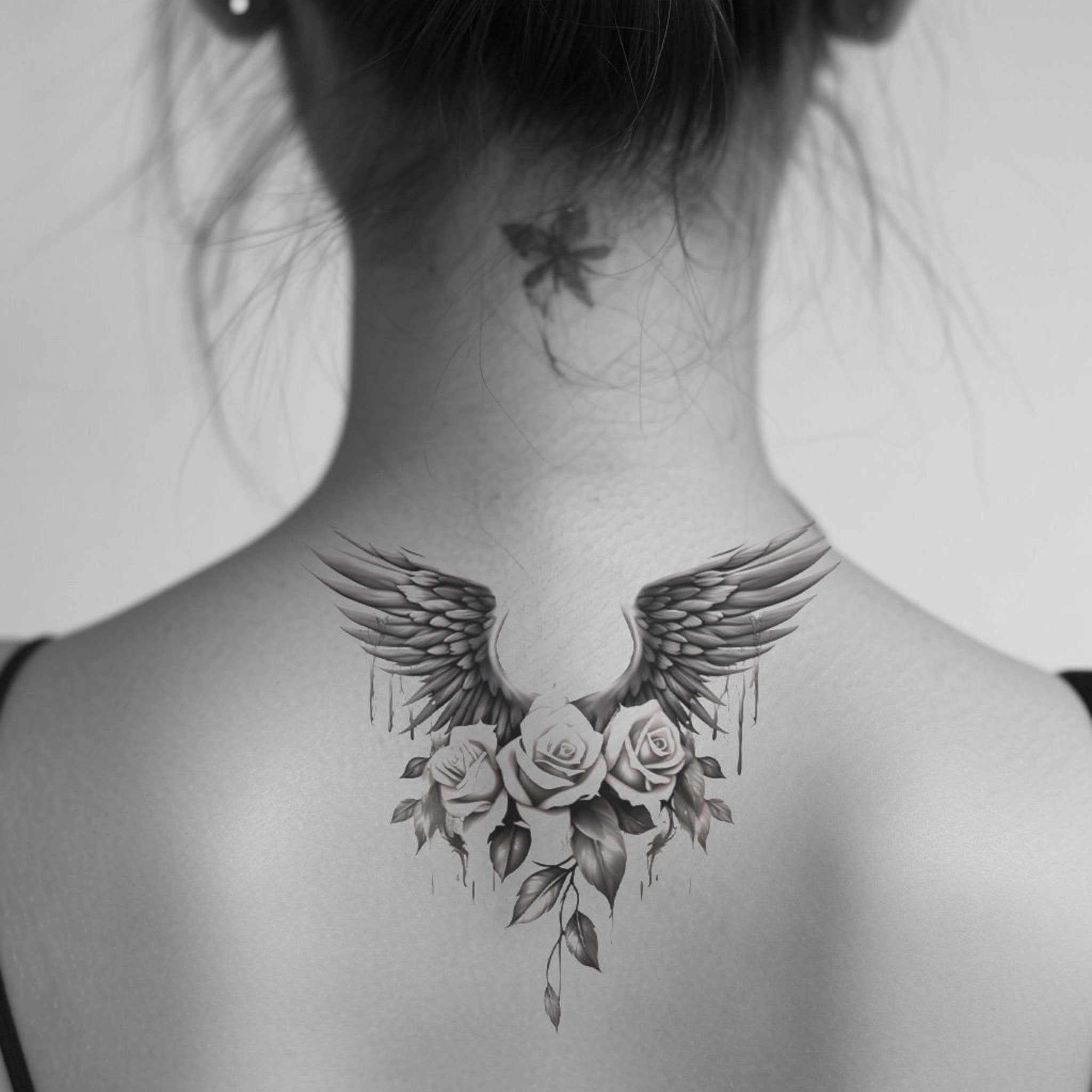 Close-up of skin-safe tattoo stencil with intricate rose and wing design in high-res detail for precise application