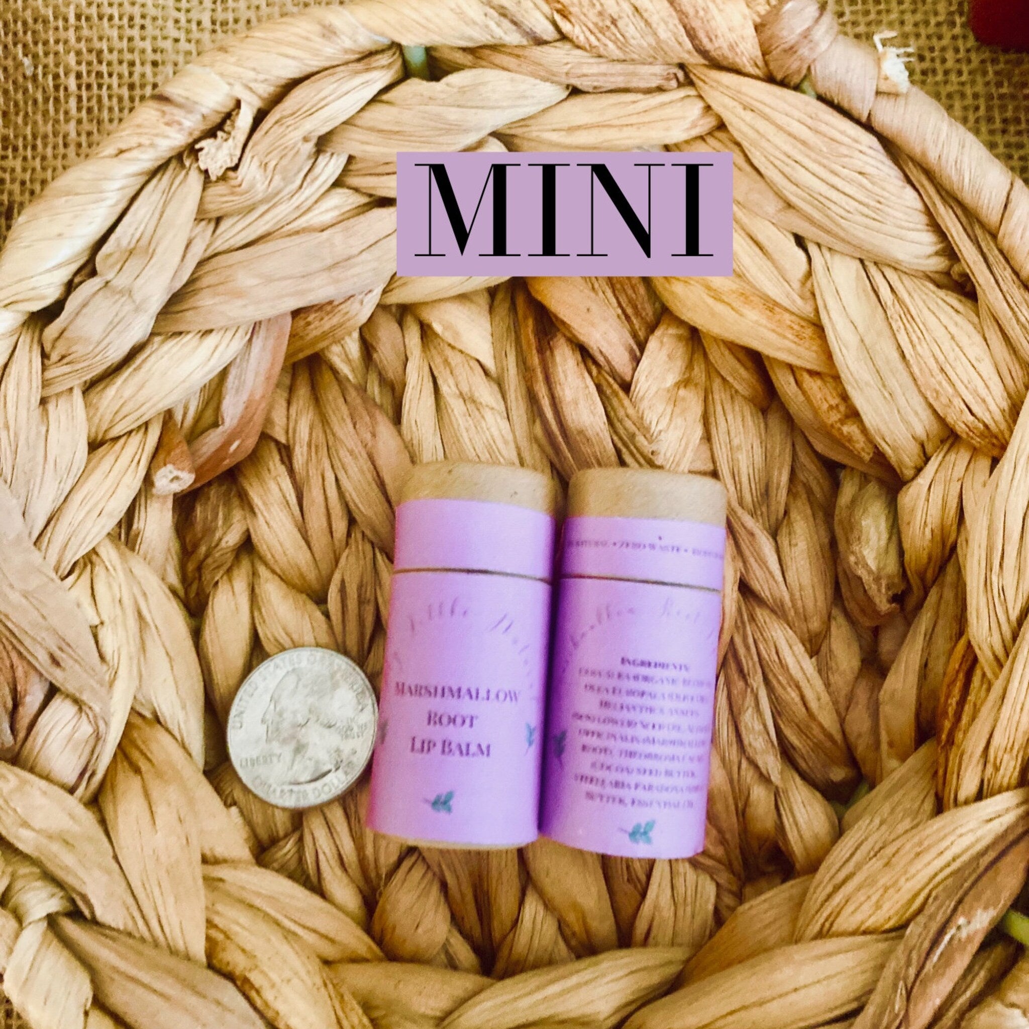 Lip balm tubes, purple with text, sitting on woven brown basket, with quarter