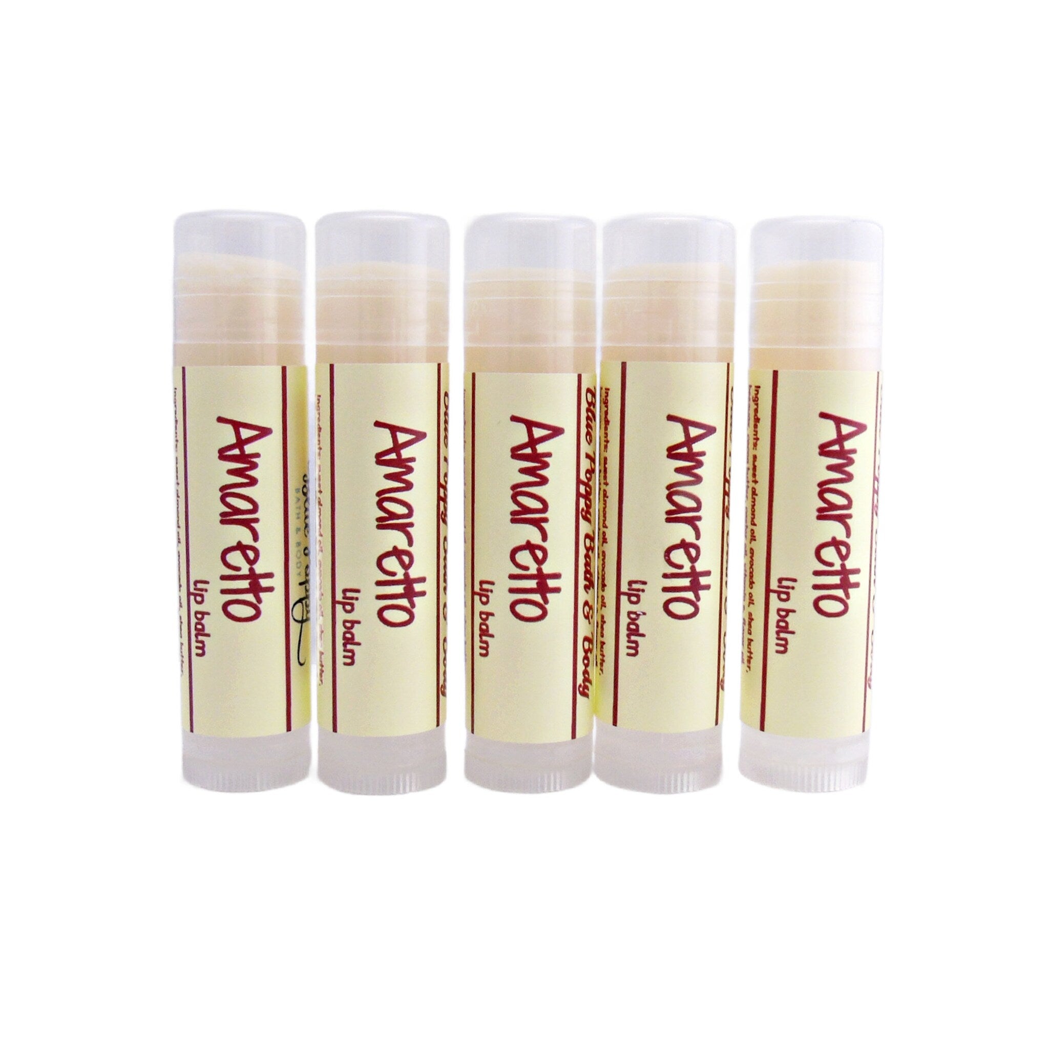 Lip balm tubes with white, cream, and red labels, with "Amaretto" text visible