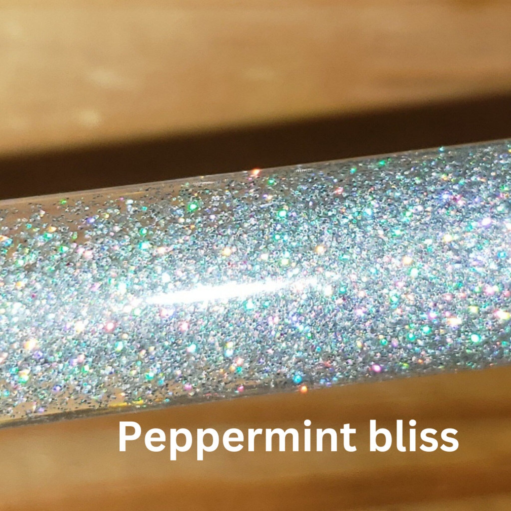 Glittery silver material with Peppermint bliss text on a light brown background