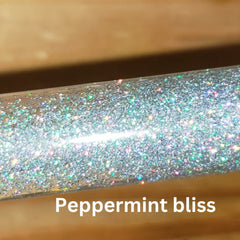 Glittery silver material with Peppermint bliss text on a light brown background