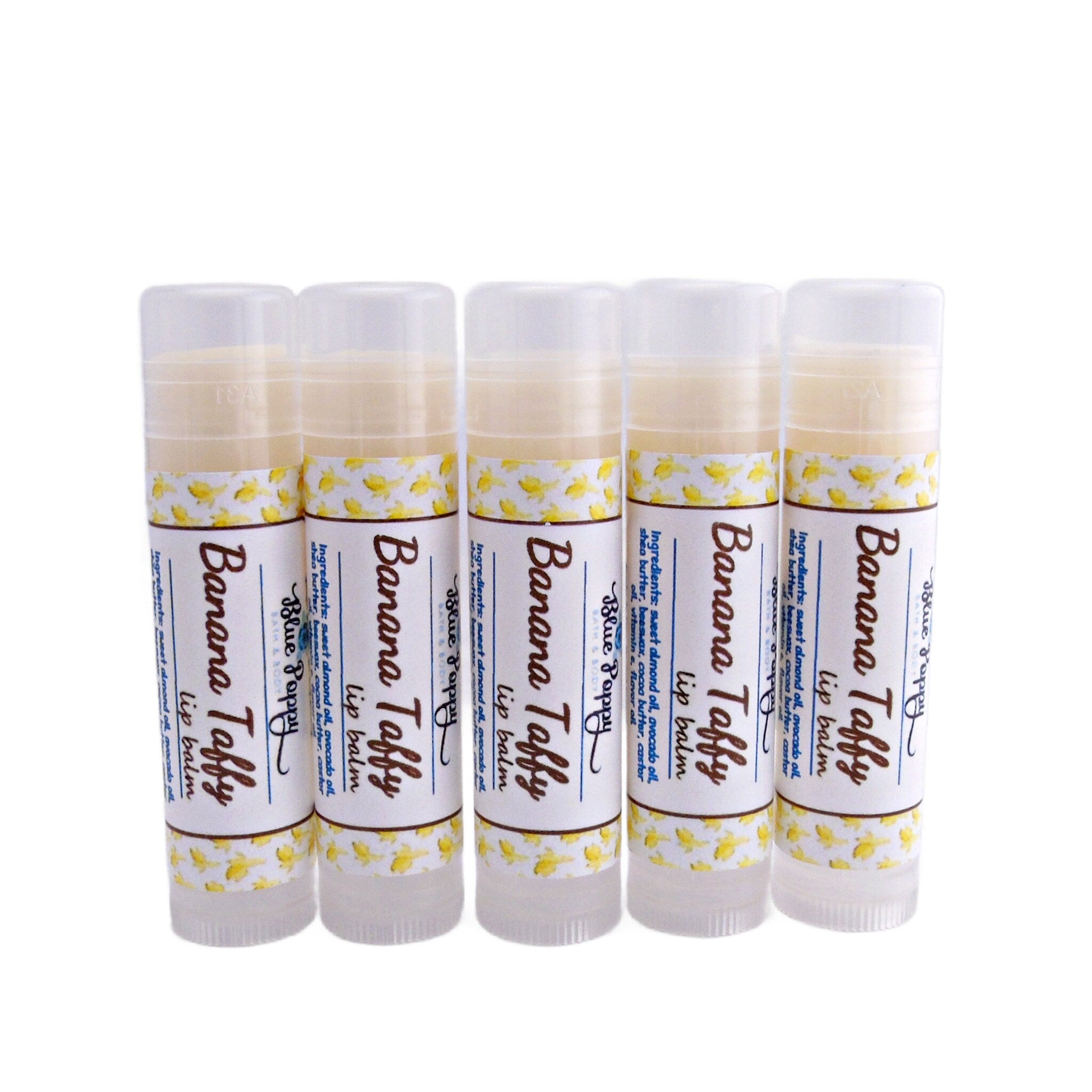 Lip balm tubes with white labels, yellow banana pattern, and clear caps, by Blue Poppy brand
