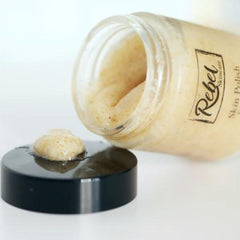 Skin polish with beige color, visible texture, and black lid, Rebel Skincare brand