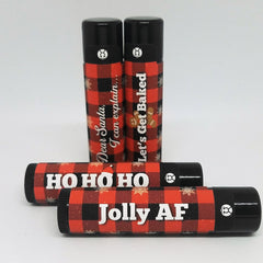 Christmas lip balms with red plaid pattern, black caps, and Venus Complete logo