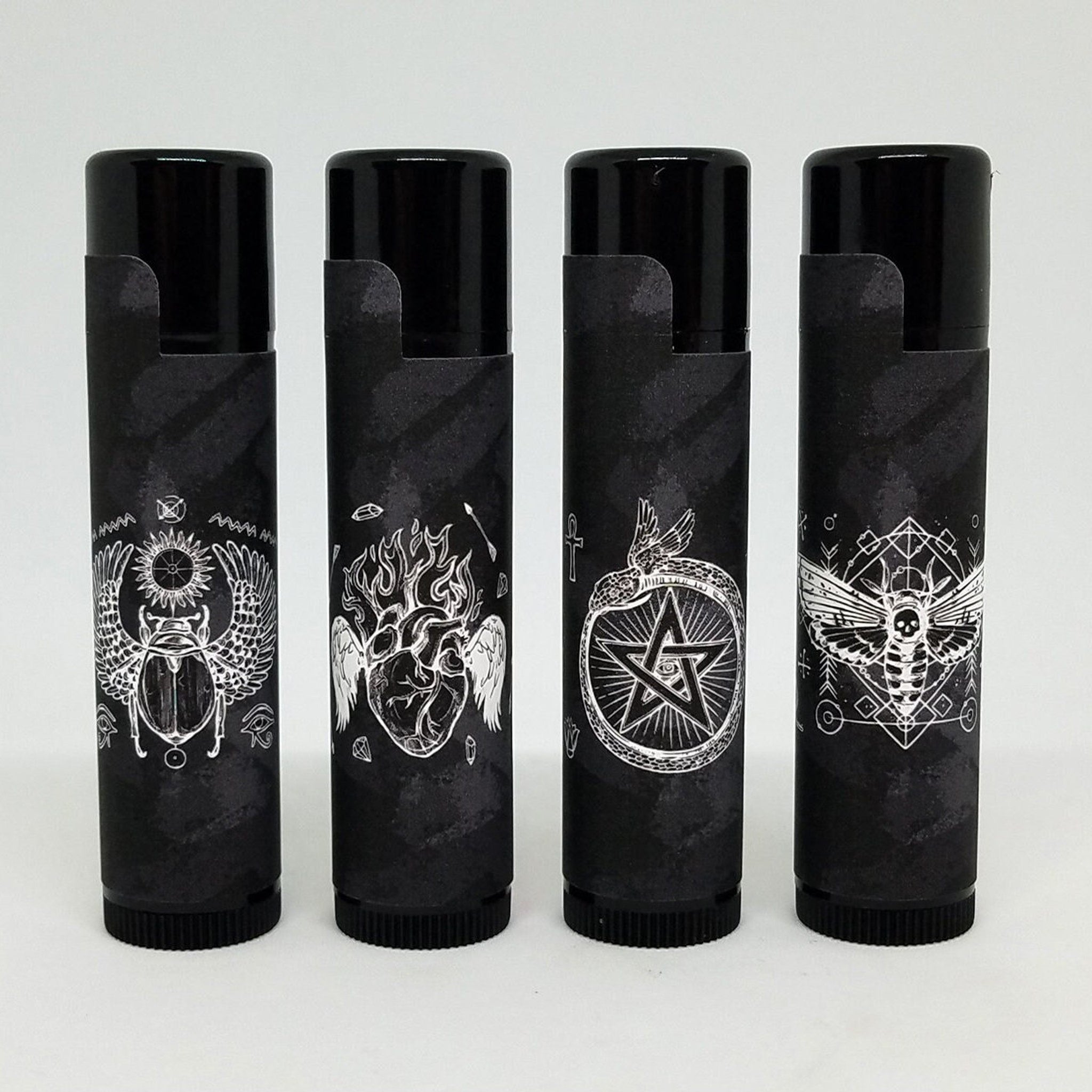 Lip balms, black tubes with white illustrations, gothic style design