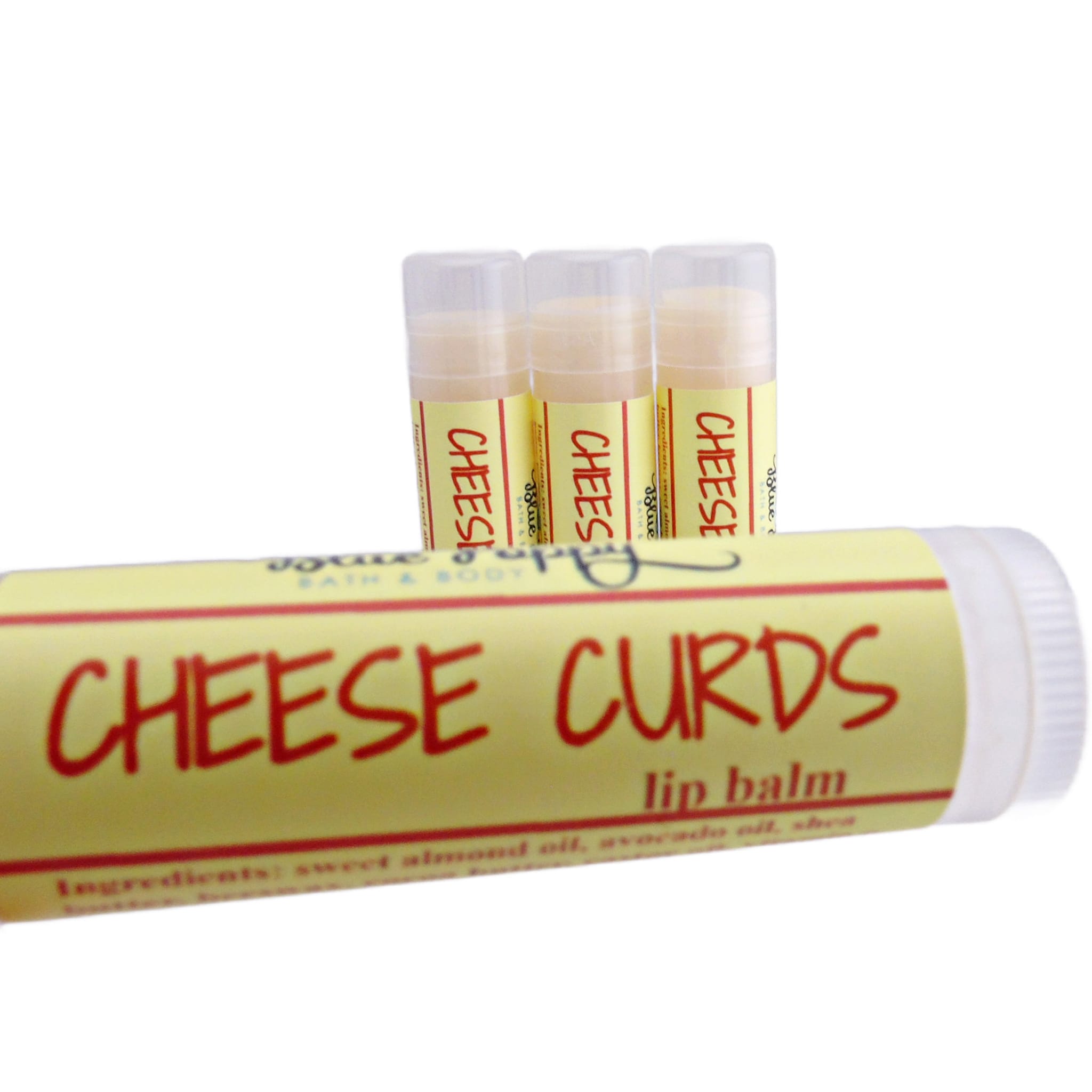 Lip balm tubes with yellow labels, red text, and clear caps, "CHEESE CURDS" on label