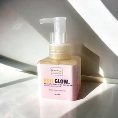 Brightening gel cleanser bottle with clear pump, pink label, and yellow liquid inside Sucré Naturals bottle