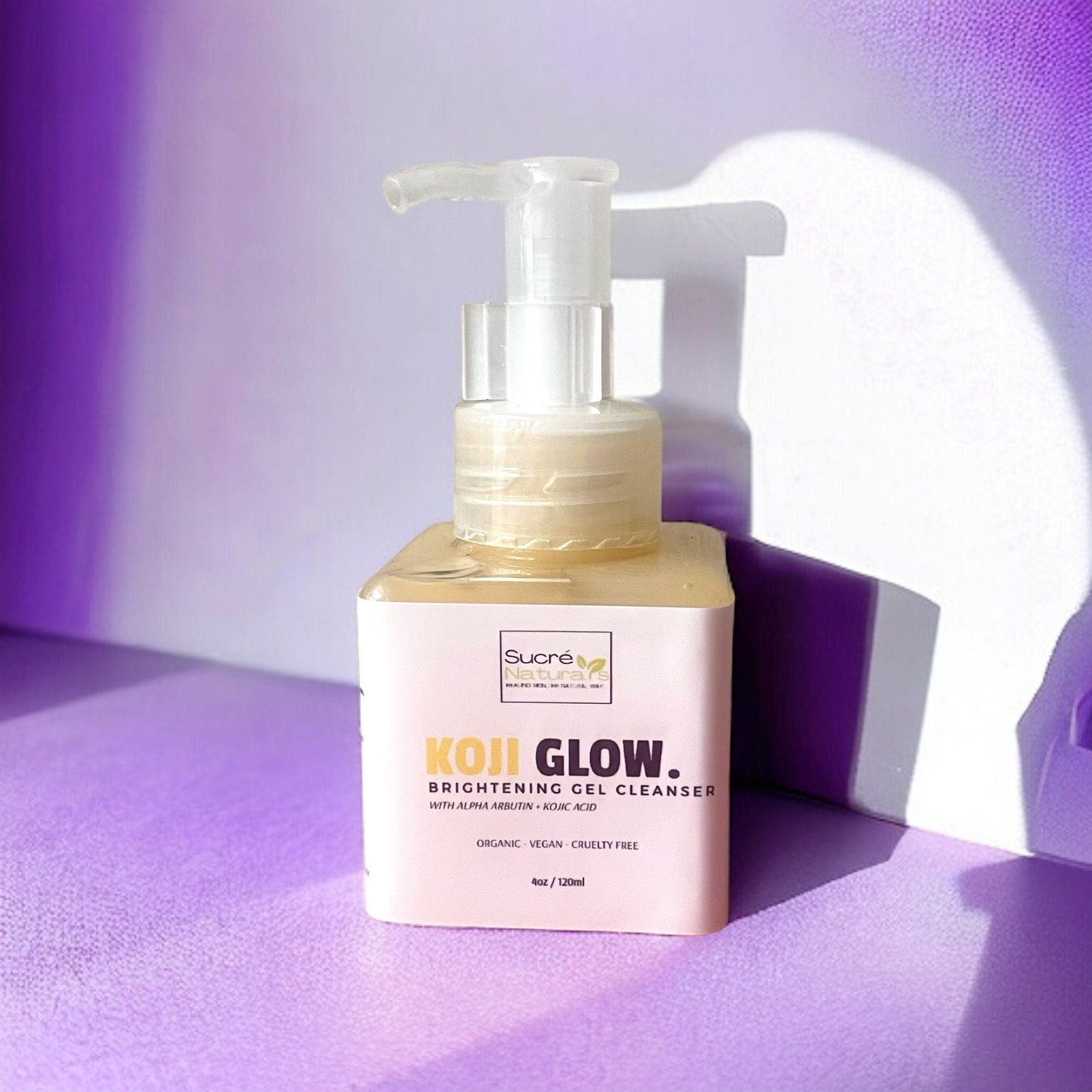 Brightening gel cleanser bottle with clear pump, beige liquid, and pink label, "KOJI GLOW" text