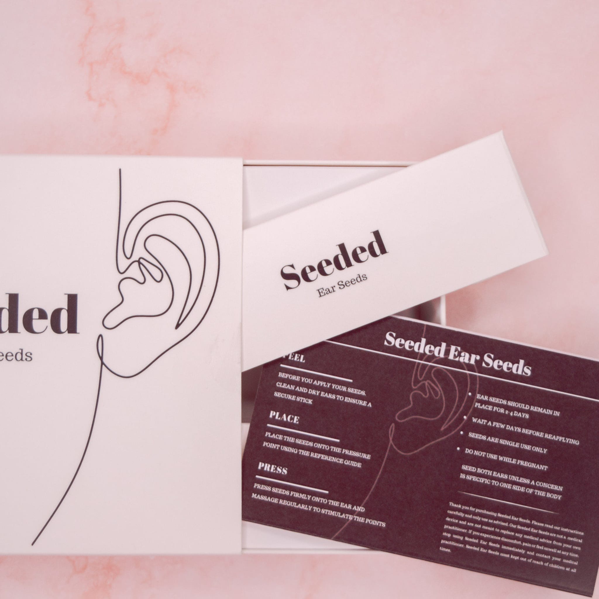 Ear seeds packaging with white box, black text, and Seeded brand name