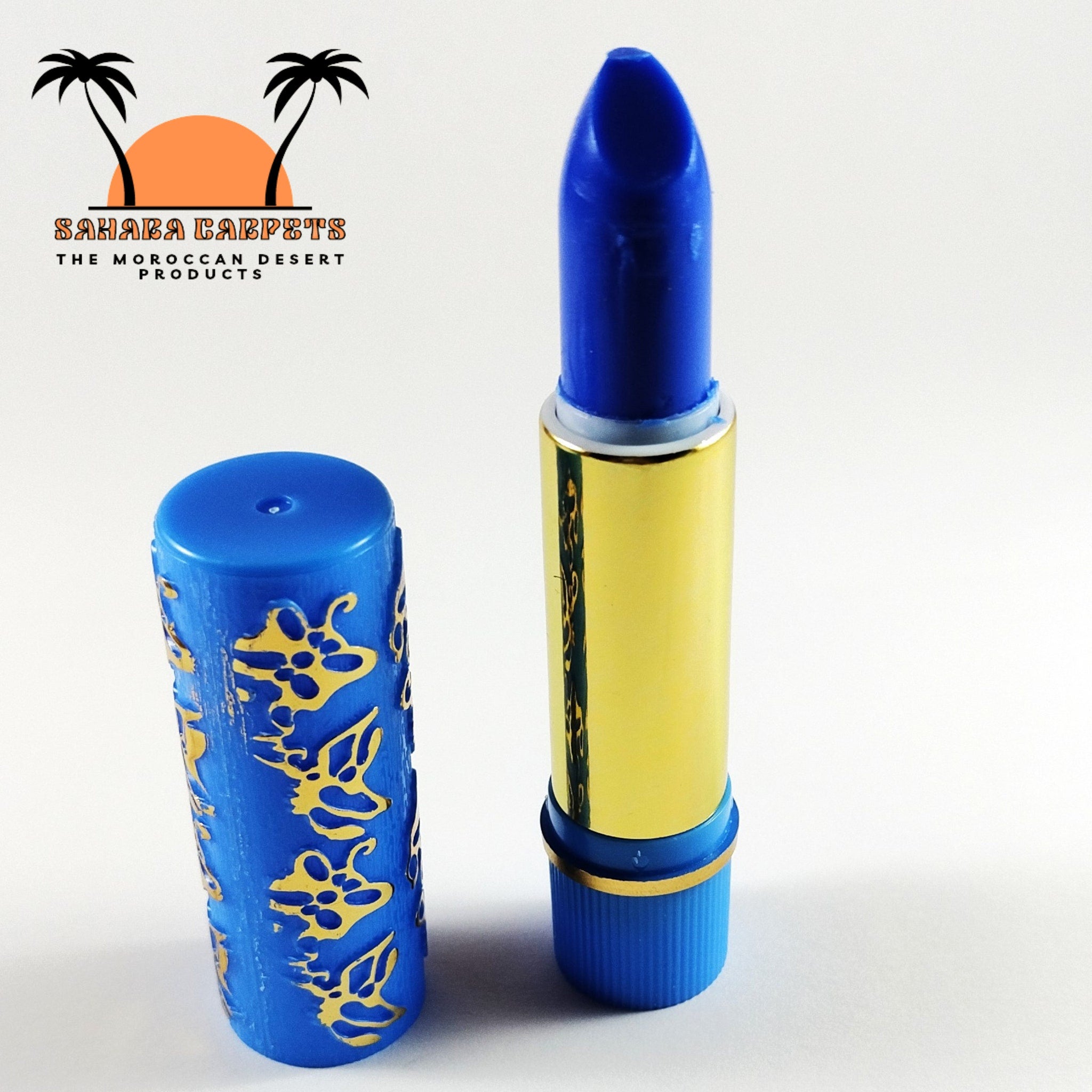 Lipstick, blue and gold tube, with embossed gold pattern and open lid